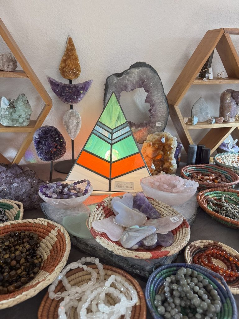 Stained glass triangle with bowls of polished crystals and gua sha stones